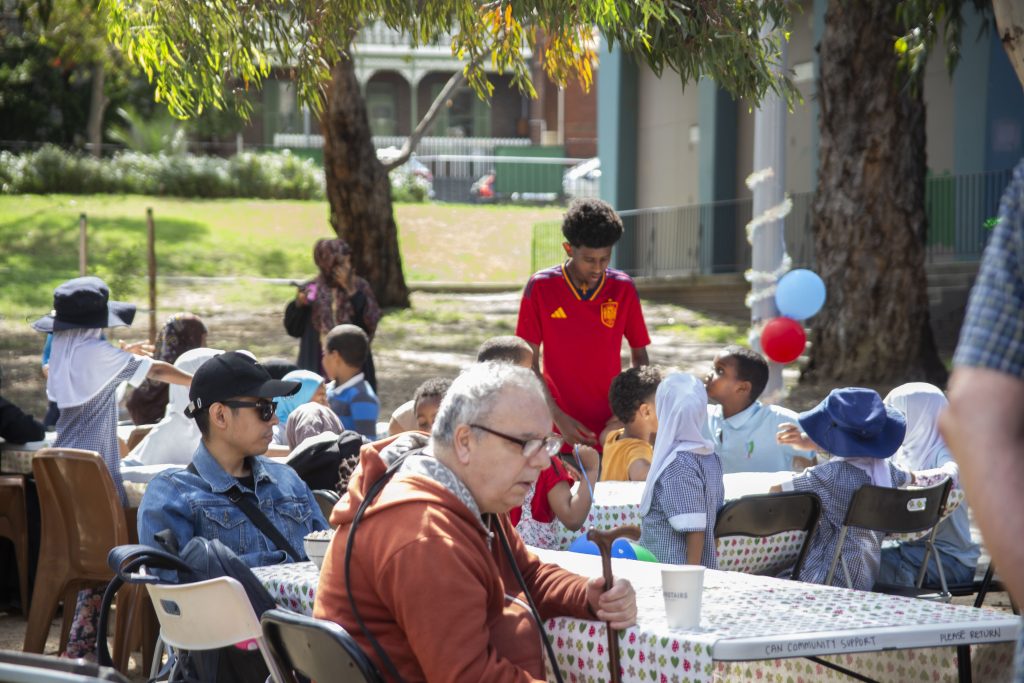 A group of people enjoying the community lunch